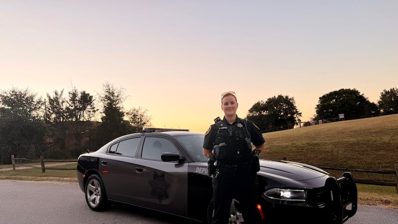 Deputy Cat Jumper stands in front of her patrol car in Greenville County.