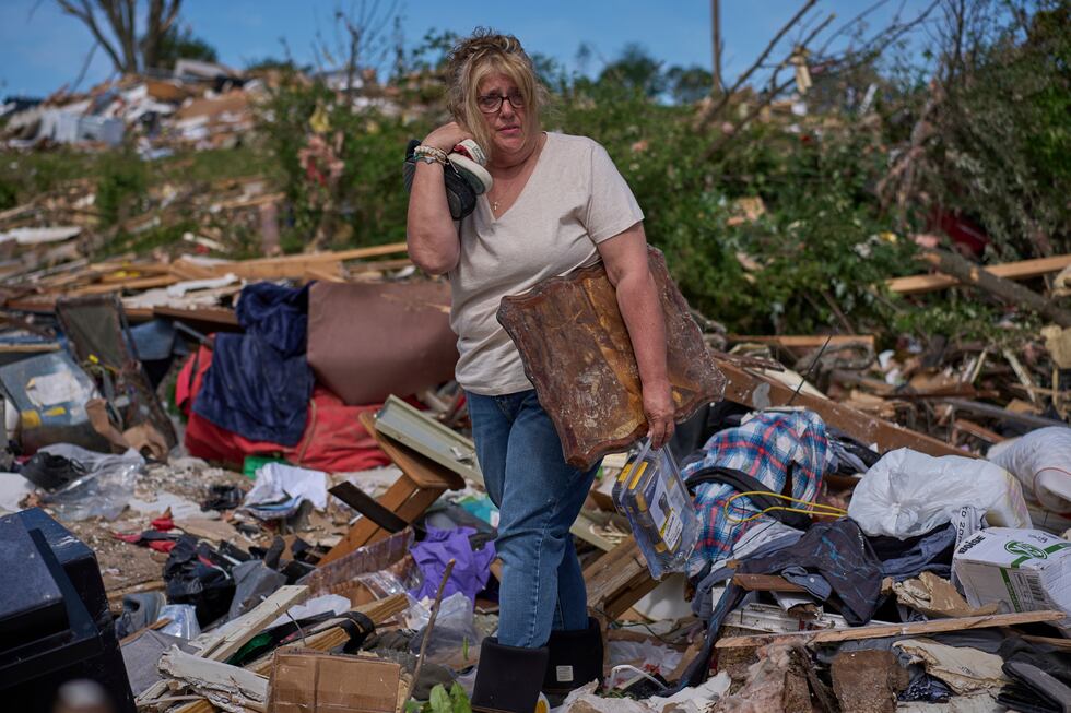 Edwina Wilson stands in what is left of her destroyed home, Sunday, May 18, 2025, in London,...